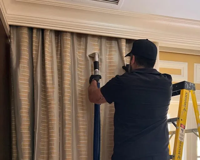 Steam cleaning wand working across patterned drapery fabric