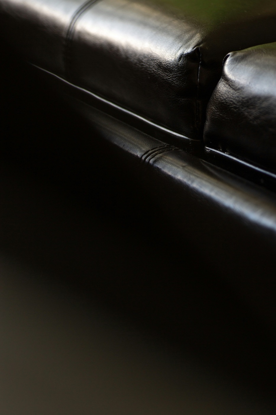 Close-up of a clean black leather sofa