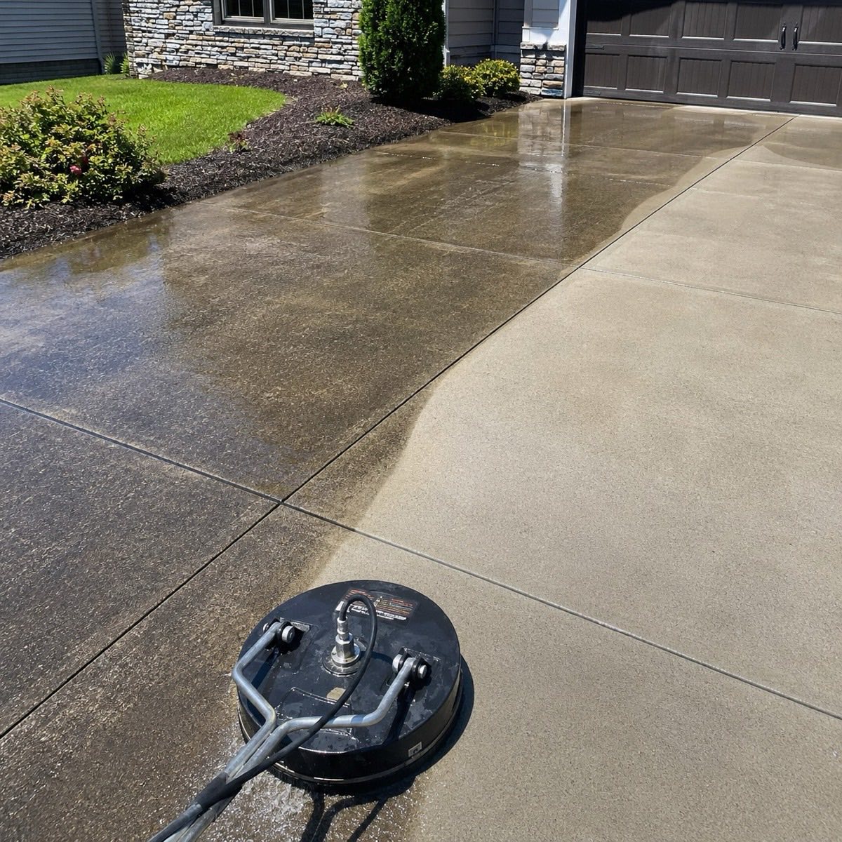 Concrete driveway with a clean pass cutting across the weathered surface