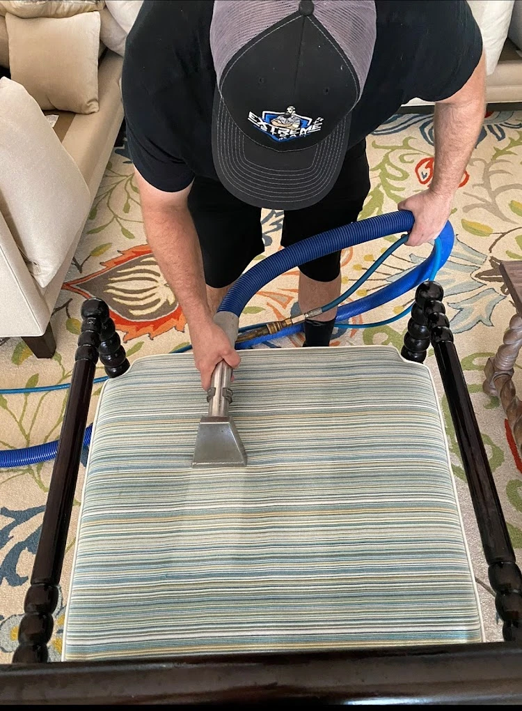 Cleaning a striped dining chair cushion with an extraction tool